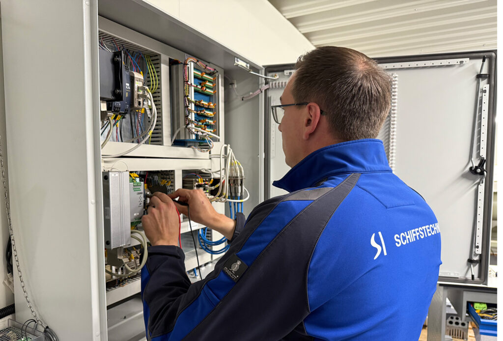 An aftersales employee repairs something.